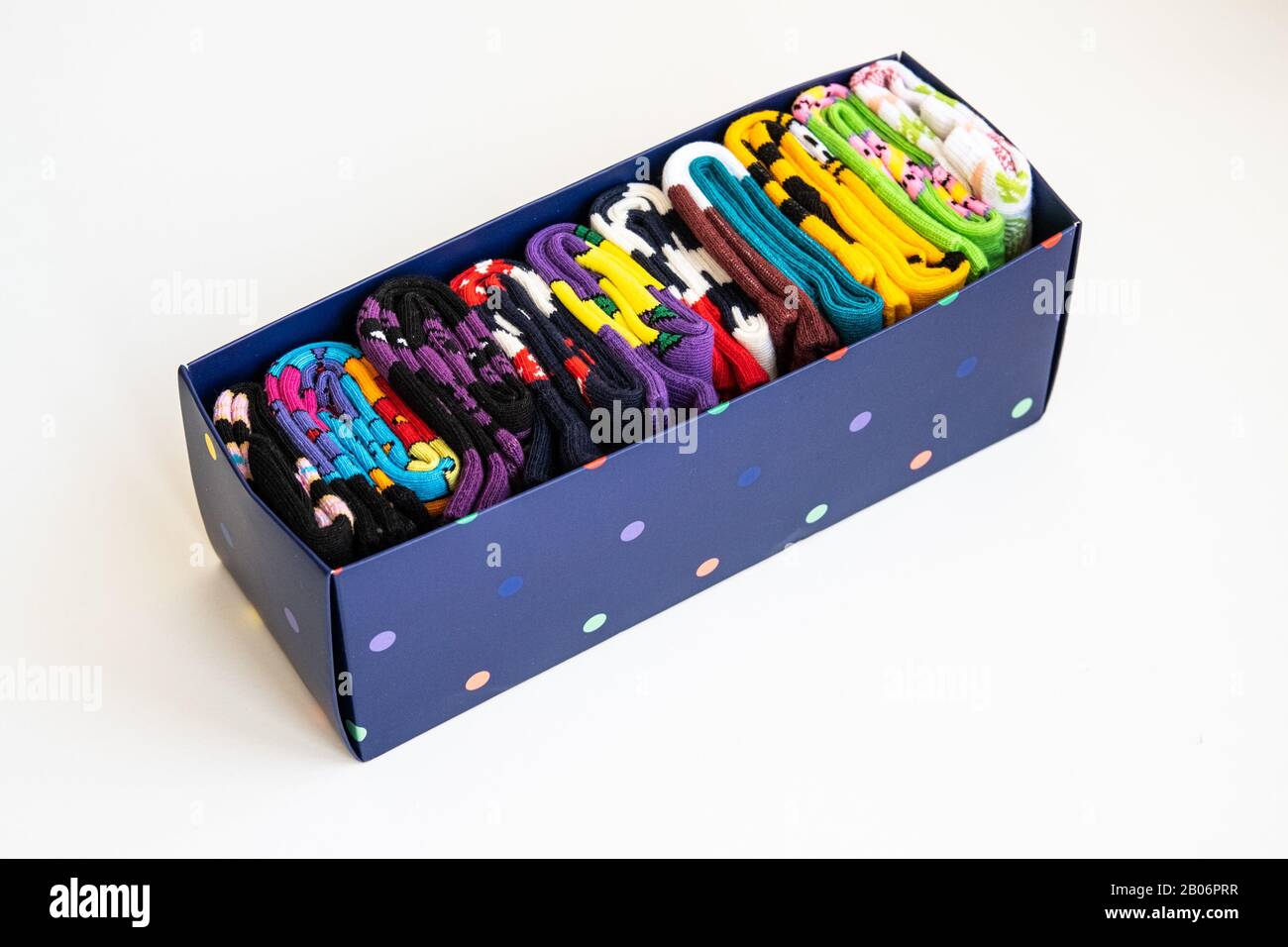 Boîte en carton bleu avec chaussettes colorées bien repliées. Style de vie minimaliste, concept de débrayer et de tri. Banque D'Images