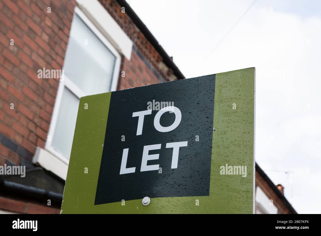Royaume-Uni locations vertes Pour Laisser la propriété de location signer avec la maison en brique rouge en arrière-plan. Portefeuille immobilier de placement propriétaire Banque D'Images