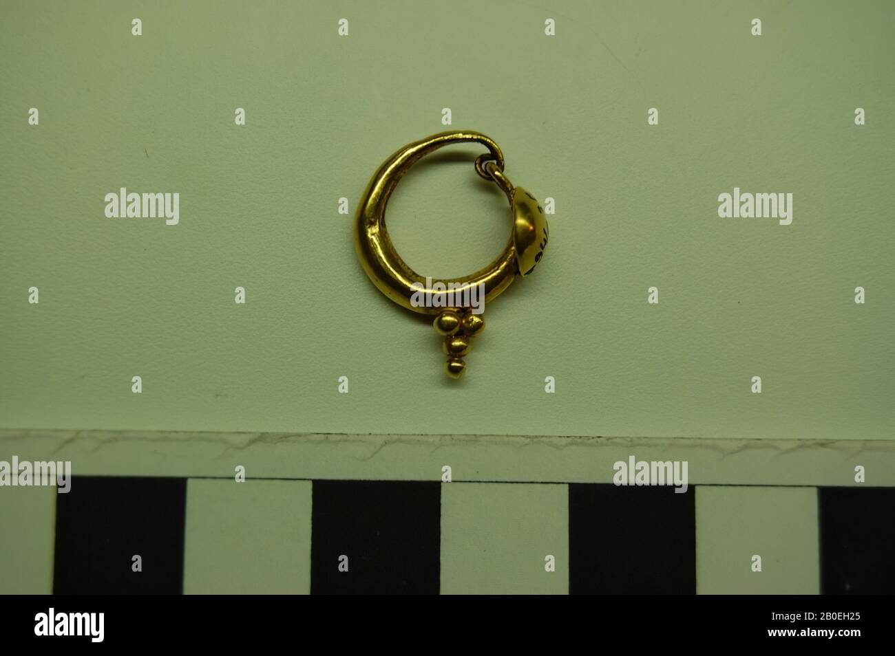 Contour d'oreille assez épais avec écran rond, le fond de l'anneau est décoré de plusieurs boules., anneau d'oreille, or, 2 cm, ø 1.5 cm, 100 Banque D'Images