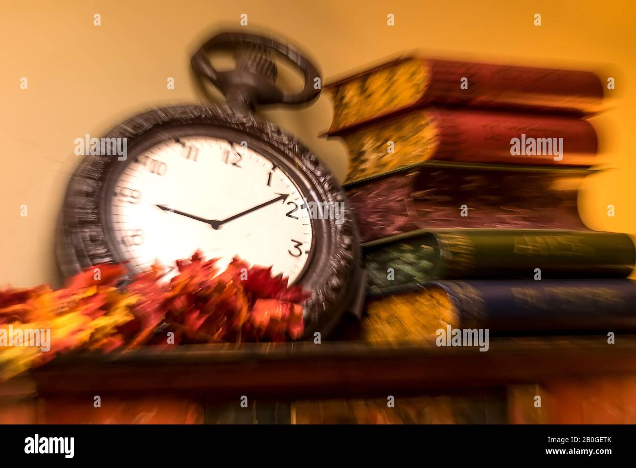 Aiguilles d'horloge et vieux livres représentant l'heure. Mouvement flou. Banque D'Images