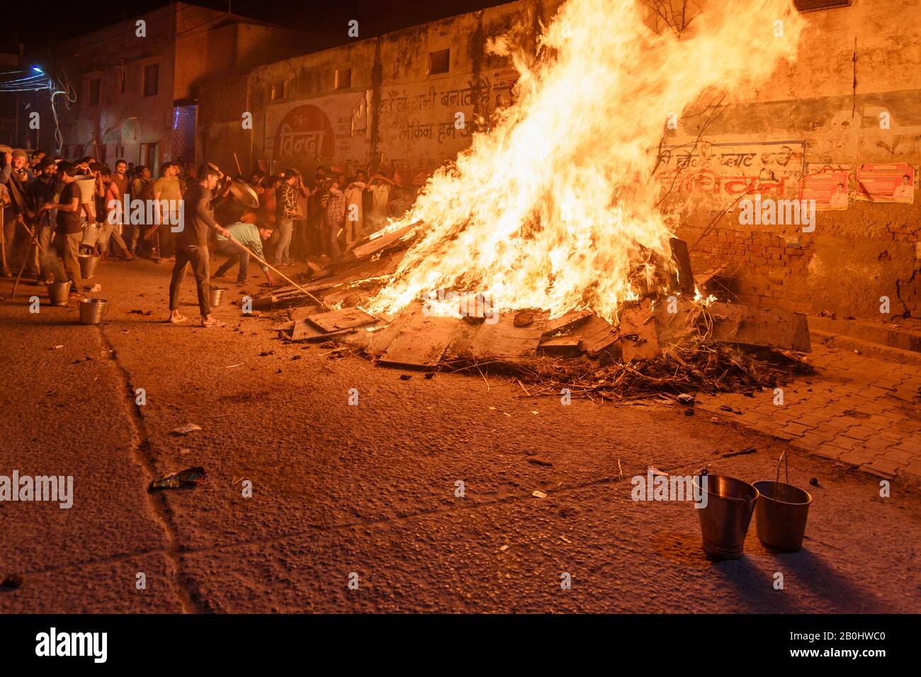 Les gens qui tirent du charbon déportant la figure mythique de Prahlad du feu traditionnel de Halika Dahan sur le festival hindou de Hali. Vrindavan. Inde Banque D'Images