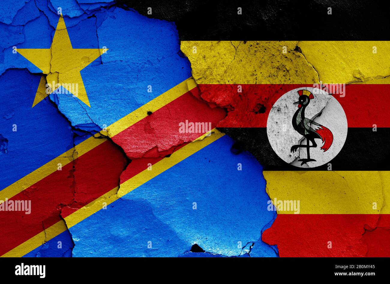 Drapeaux de la RD Congo et de l'Ouganda peints sur un mur fissuré Banque D'Images