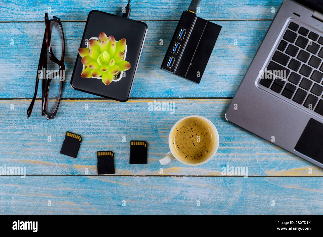 Vue de dessus de bureau et les photographes verres à café, ordinateur  portable avec disque dur disque dur externe, carte SD sur table en bois  Photo Stock - Alamy
