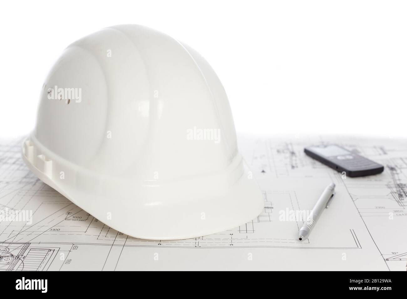 Casque blanc, téléphone et stylo à bille allongé sur un plan de construction - fond blanc Banque D'Images