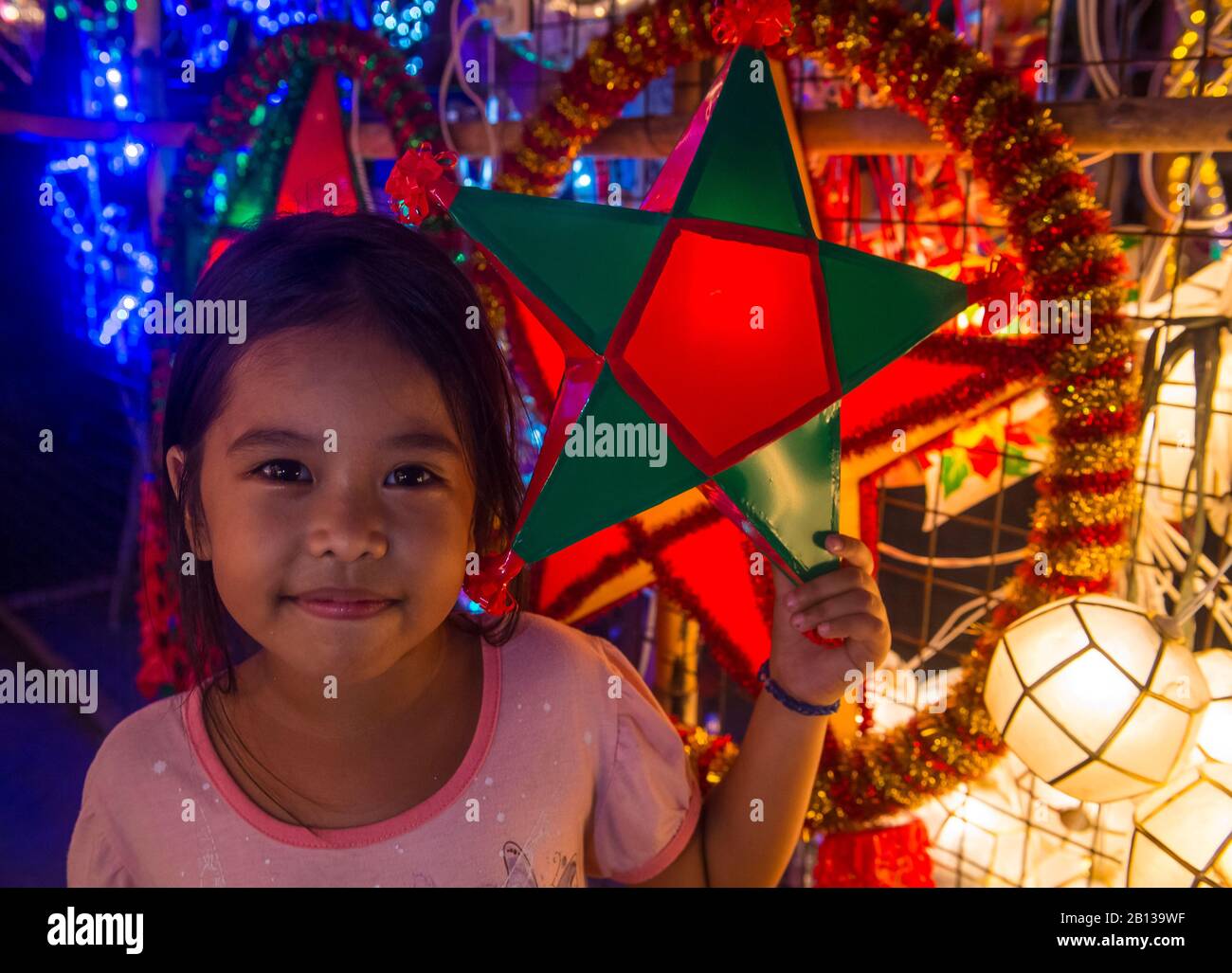 Fille philippine tenant une lanterne dans un marché de Noël dans la ville de Las Pinas , Manille les Philippines Banque D'Images