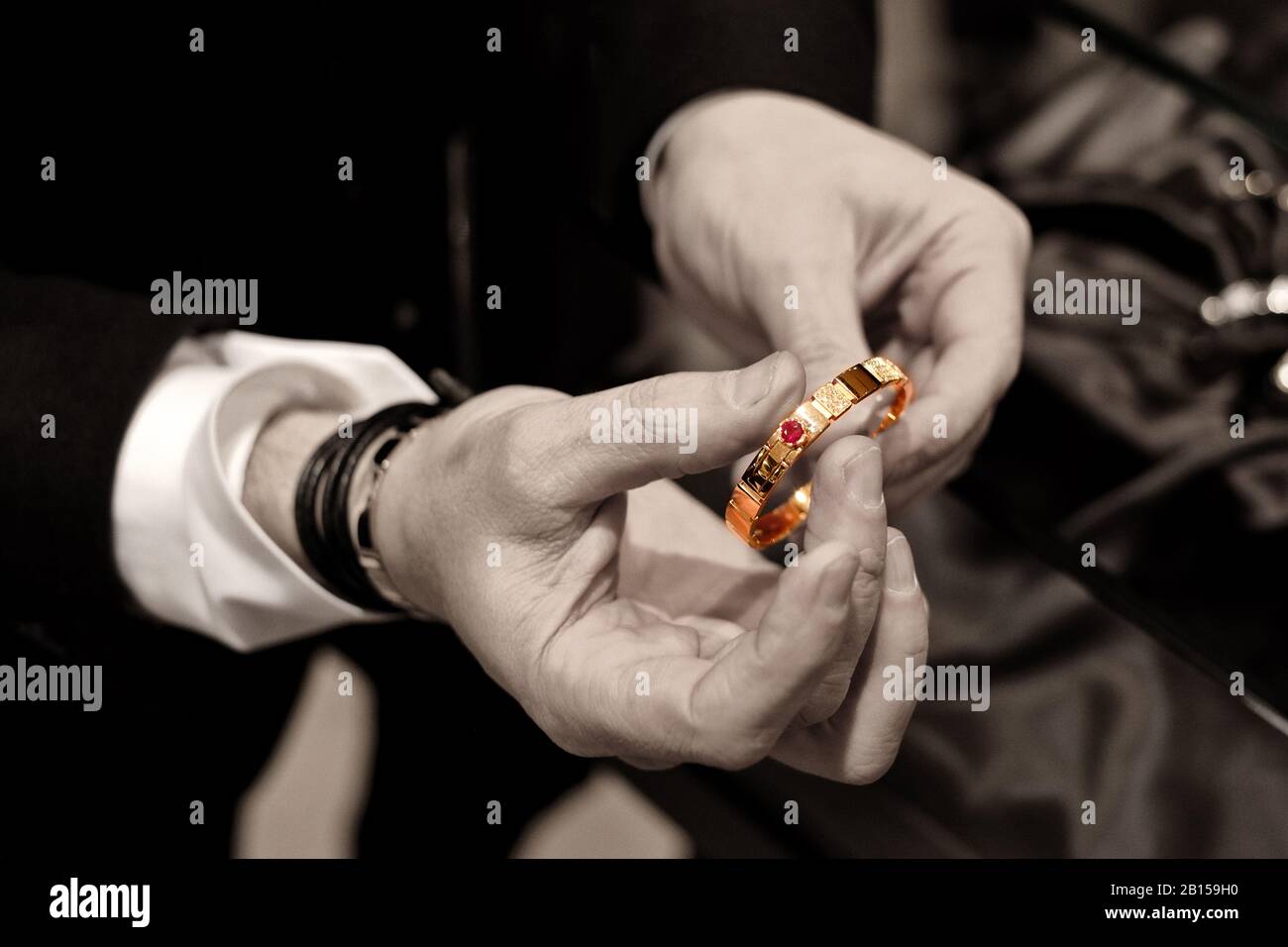 Les mains de Stefano Canturi montrant un bracelet en or et saphir à une présentation spéciale de bijoux de luxe et de la fête du déjeuner Canturi à Sydney Banque D'Images