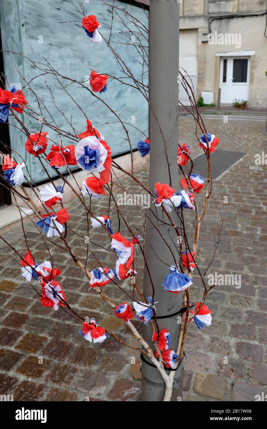 France, Normandie, Décoration pour les fêtes de la journée du D (6 juin 1944 au début de l'atterrissage allié en Normandie pendant la seconde Guerre mondiale) - fleurs rouges, blanches et bleues en papier Banque D'Images
