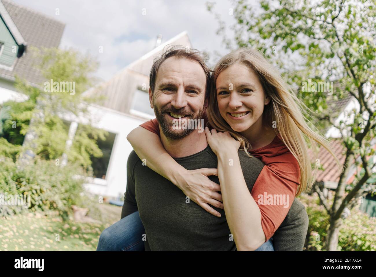 Heureux couple debout dans leur jardin Banque D'Images