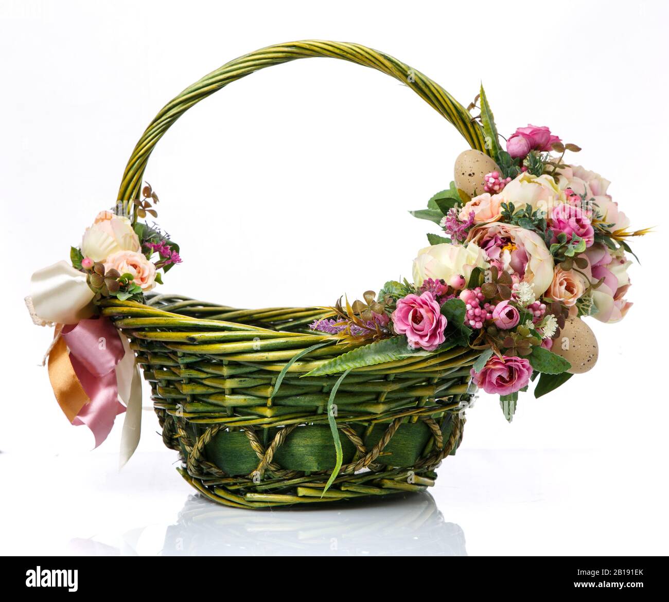 Magnifique panier décoratif avec fleurs pour la fête de Pâques sur fond blanc Banque D'Images
