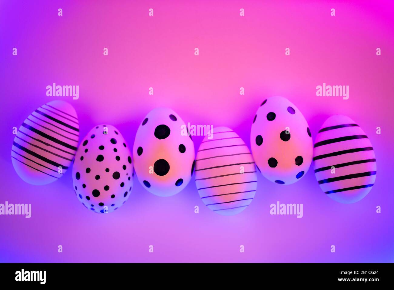 Autre graphique dans les œufs peints à la main pourpre Proton neon light. Concept de Pâques. Vue d'en haut. Banque D'Images