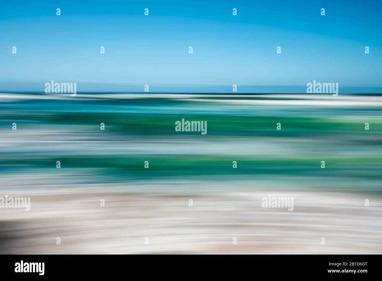 Paysage marin abstrait avec mouvement panoramique flou. L'image affiche un jeu de couleurs bleu et turquoise clair dans un ton divisé. Banque D'Images