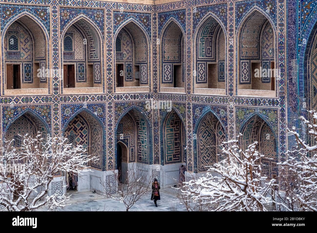 Une femme se tient dans les terres du Registan à Samarkand, en Ouzbékistan. Banque D'Images