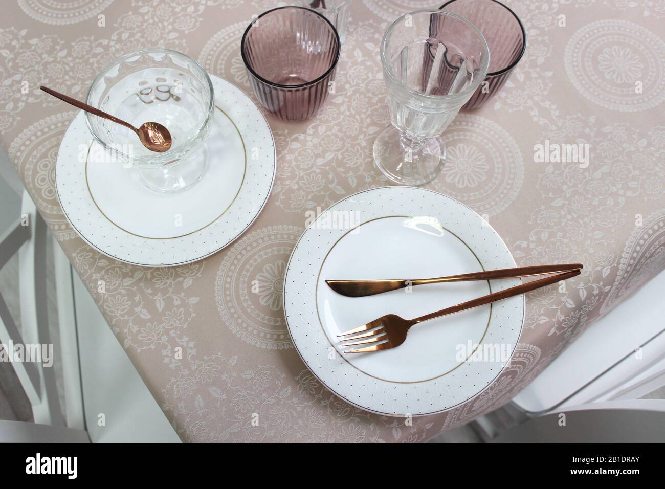 assiettes blanches sur une table avec couverts et fleurs, vue sur le dessus, Banque D'Images