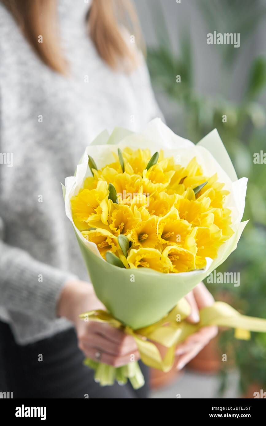 Narcisse. Bouquet de fleurs de couleur jaune dans la main des womans. Le  travail du fleuriste dans un magasin de fleurs Photo Stock - Alamy