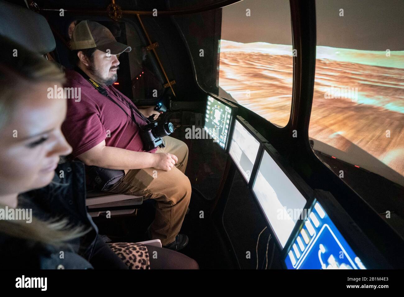 Les journalistes conduisent un futur simulateur Mars Rover à deux personnes dans le simulateur de génie des systèmes (ses) de la NASA à Houston. Banque D'Images