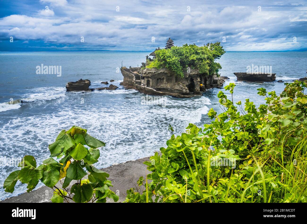 Vue sur Tanah Lot, une formation de roches au large de l'île indonésienne de Bali, qui abrite un ancien temple de pèlerinage hindou Pura Tanah Lot, Bali, Indonésie Banque D'Images