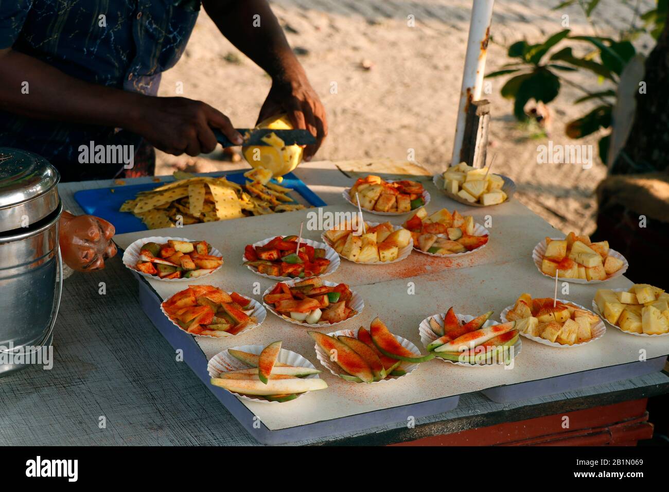 Cuisine de rue indienne dans une rue., Kerala Inde. Spécial été ananas doux et aigre, tranche de mangue. Fruits marinés avec sel et poudre de froid Banque D'Images