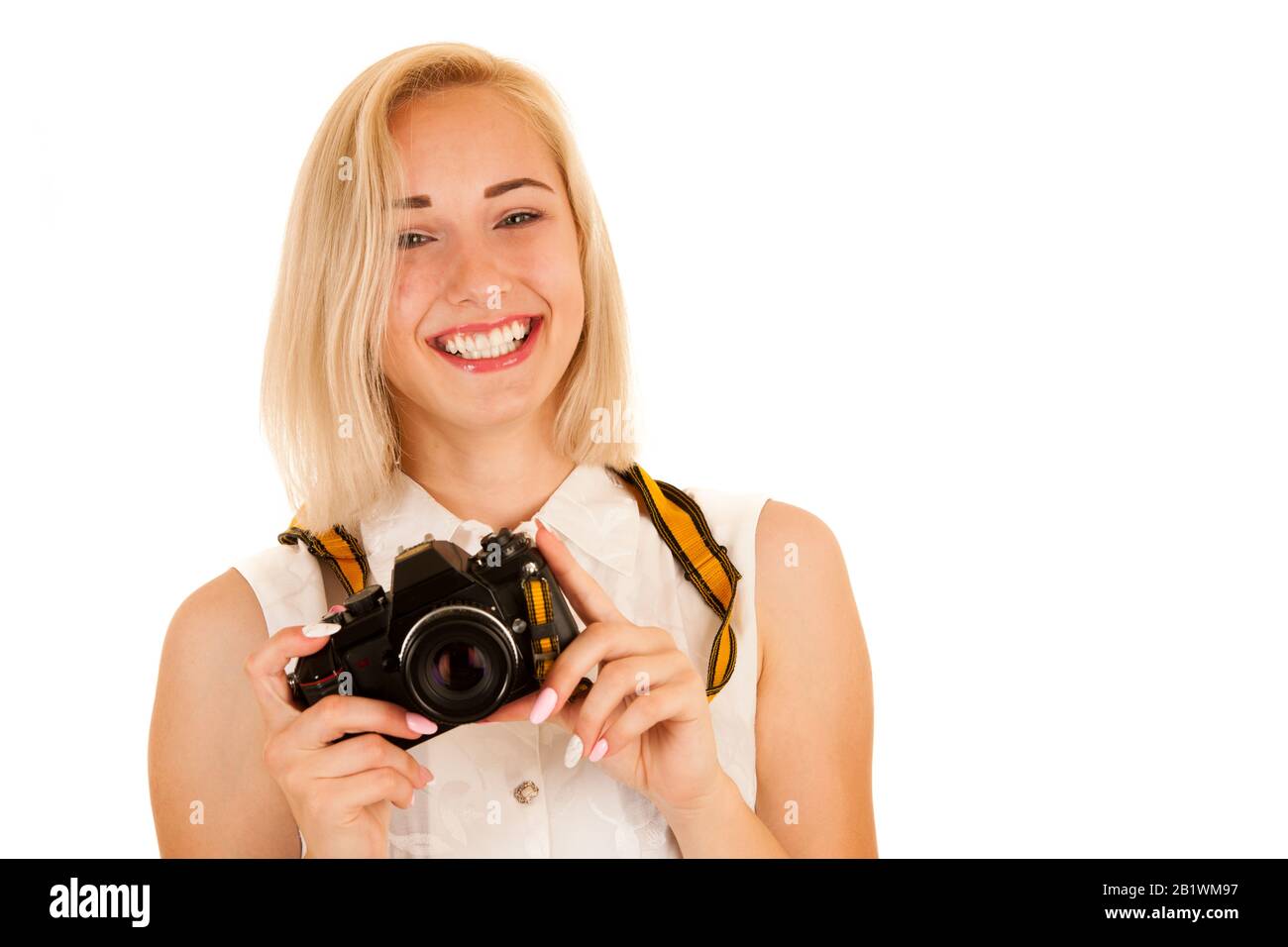 jeune femme active prenant des photos avec un appareil photo rétro isolé sur fond blanc Banque D'Images