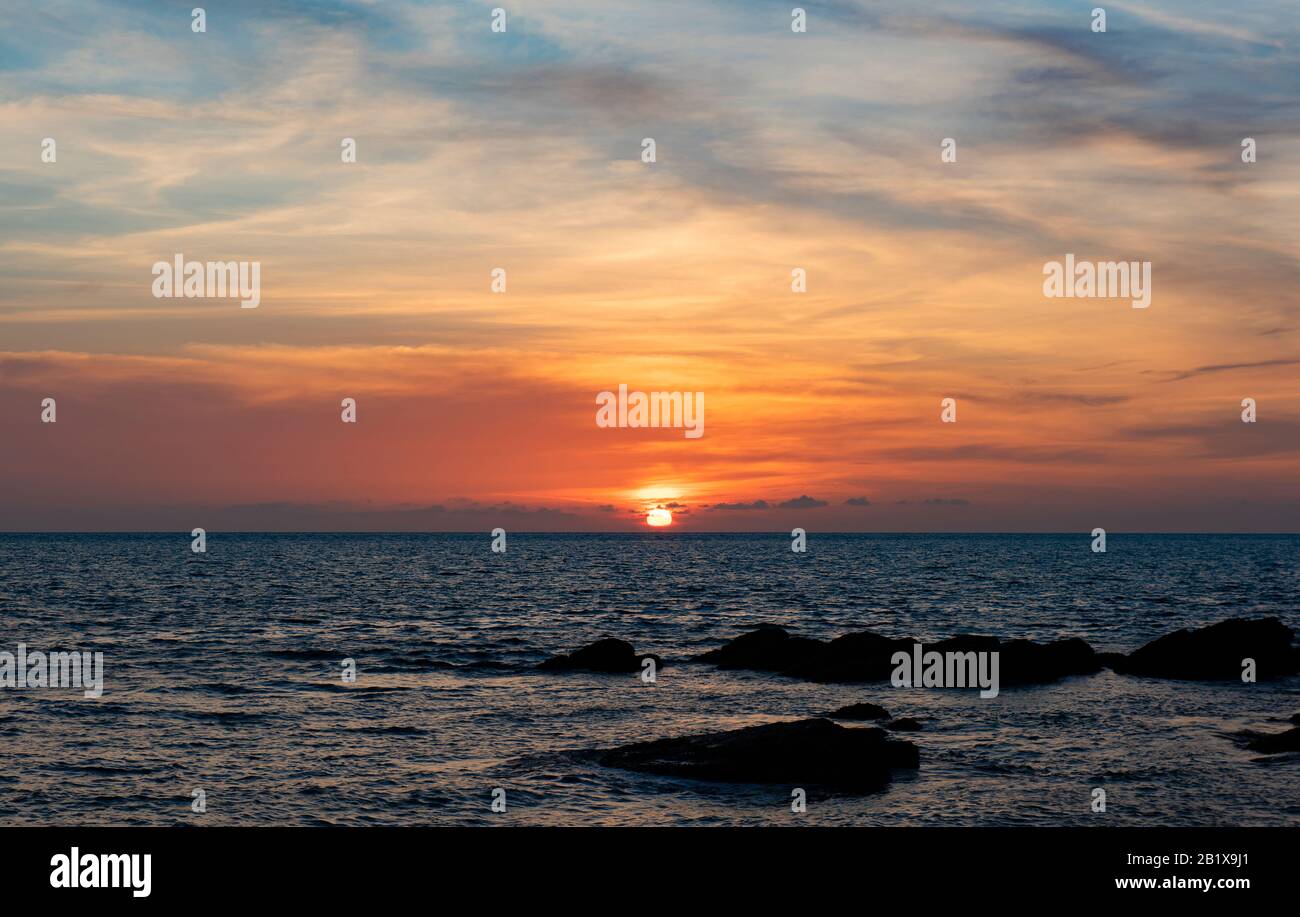 Superbe vue sur le coucher du soleil sur la plage de Krabi, Thaïlande. Magnifique paysage de coucher de soleil à la mer noire et au ciel orange. Destination de voyage et natu Banque D'Images