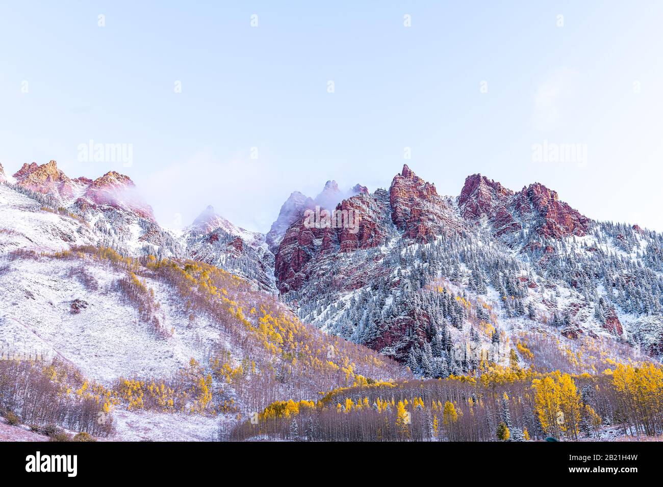 Vue sur le lever du soleil de Maroon Bells à Aspen, montagnes d'élan rouge du Colorado avec montagne rocheuse et neige à la fin de l'automne avec revêtement de nuage de brouillard d'hiver Banque D'Images
