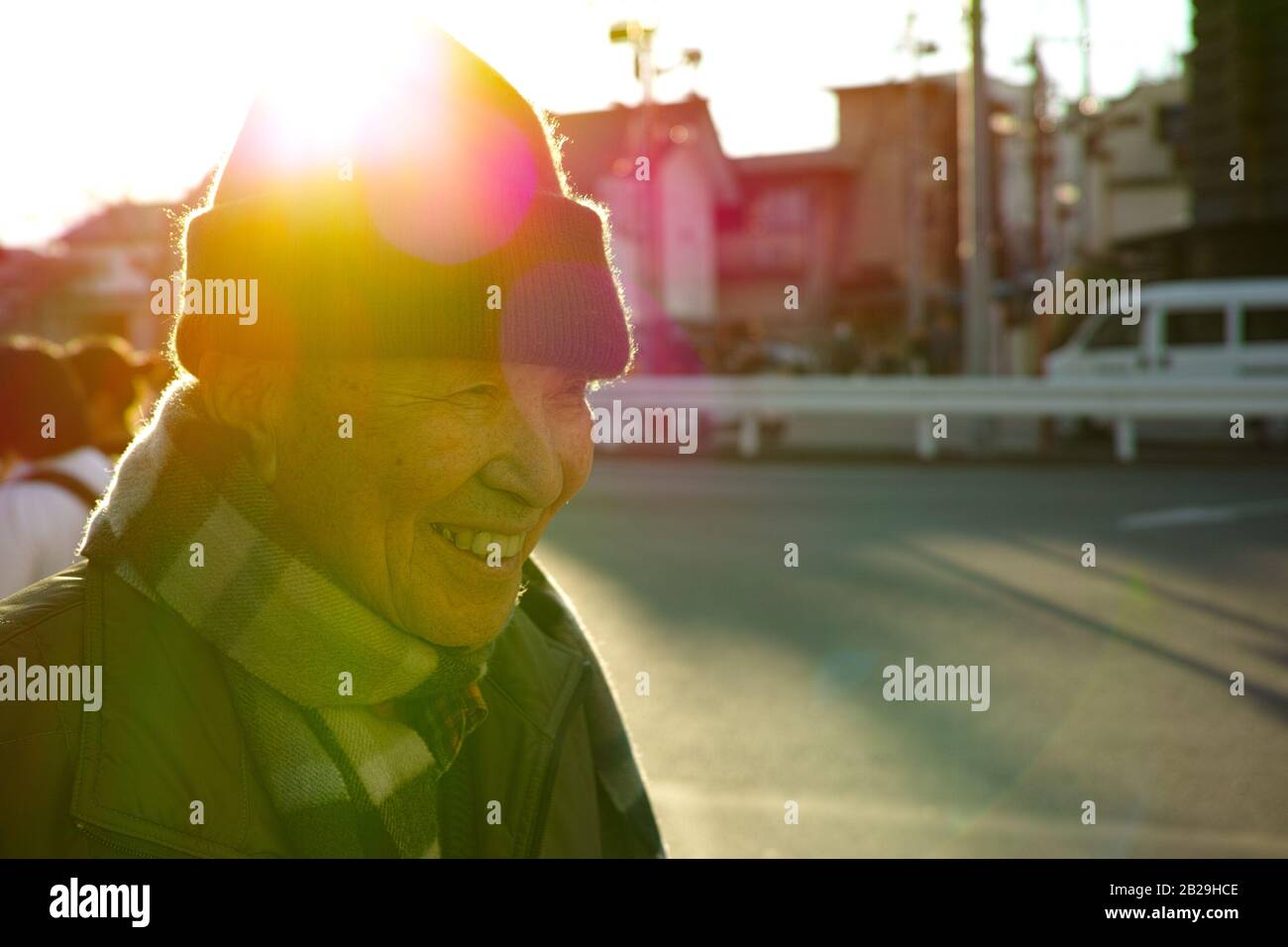 Un vieil homme asiatique marchant sur la route en hiver Banque D'Images