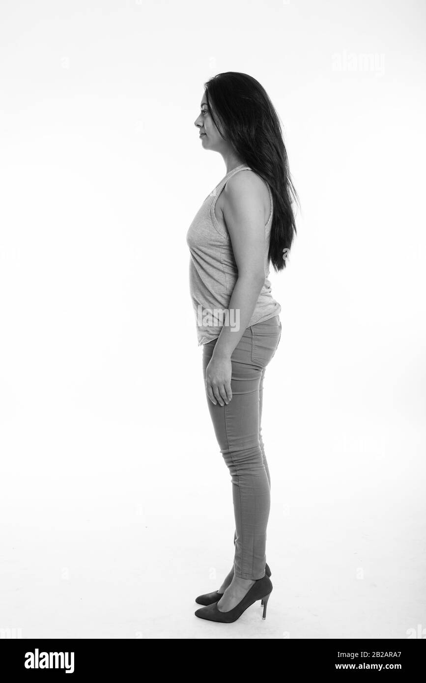 Full body shot profile view of Beautiful woman standing against white background Banque D'Images