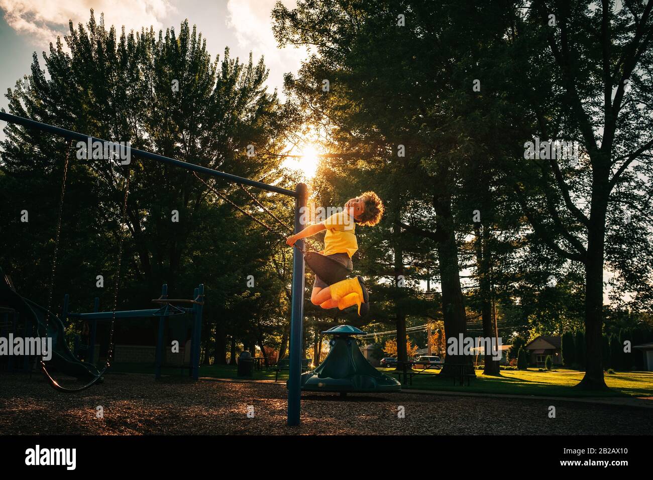 Garçon balançant sur un swing dans un parc, États-Unis Banque D'Images