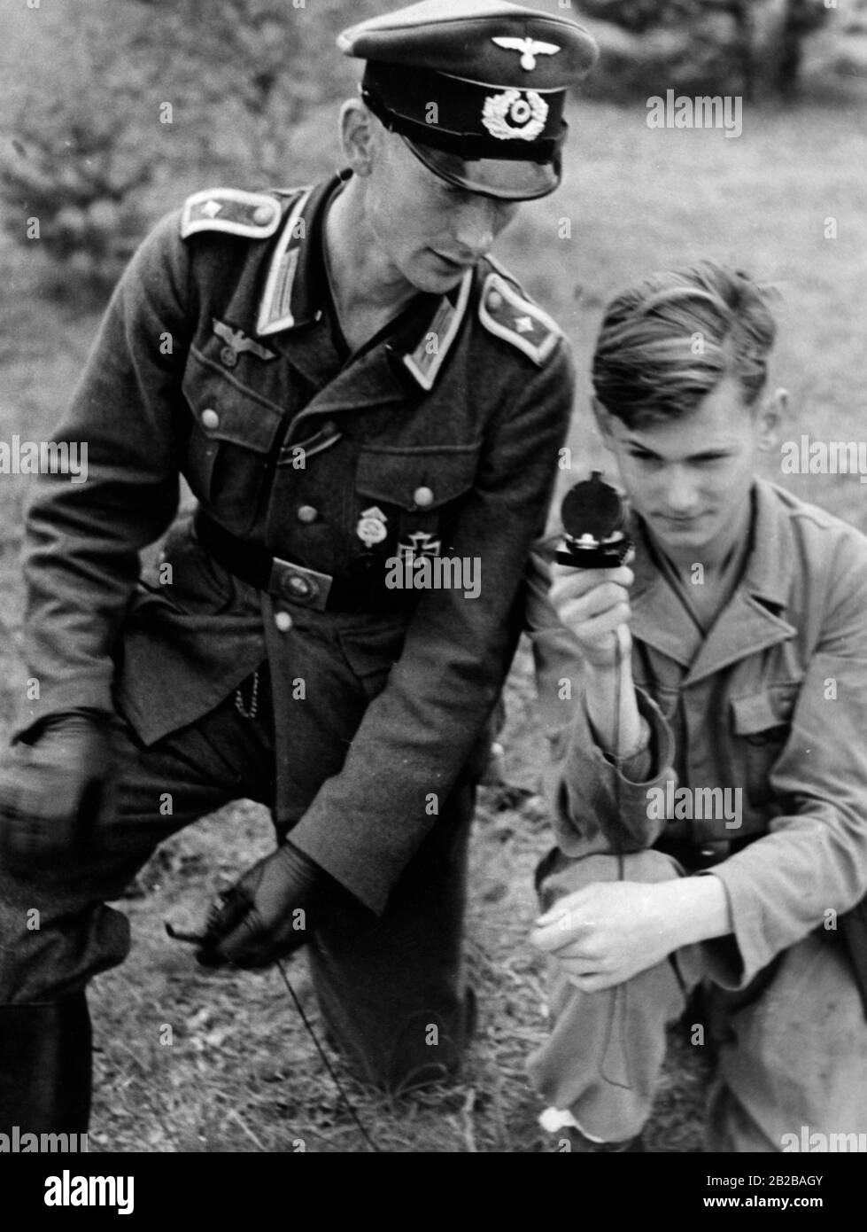 Dans les camps d'entraînement militaire, les membres de la jeunesse d'Hitler apprennent à utiliser une boussole pour les exercices dans les différents pays. Banque D'Images