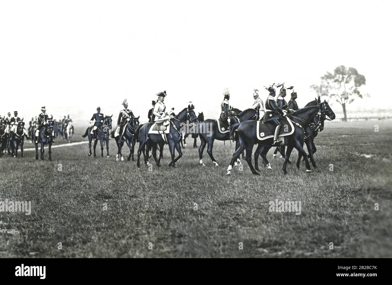 Accompagné de généraux de cavalerie, l'empereur Wilhelm II (centre droit), suivi de sa femme Augusta Victoria, passe au-dessus du champ Tempelhof près de Berlin pour visiter un détachement de cavalerie. Banque D'Images