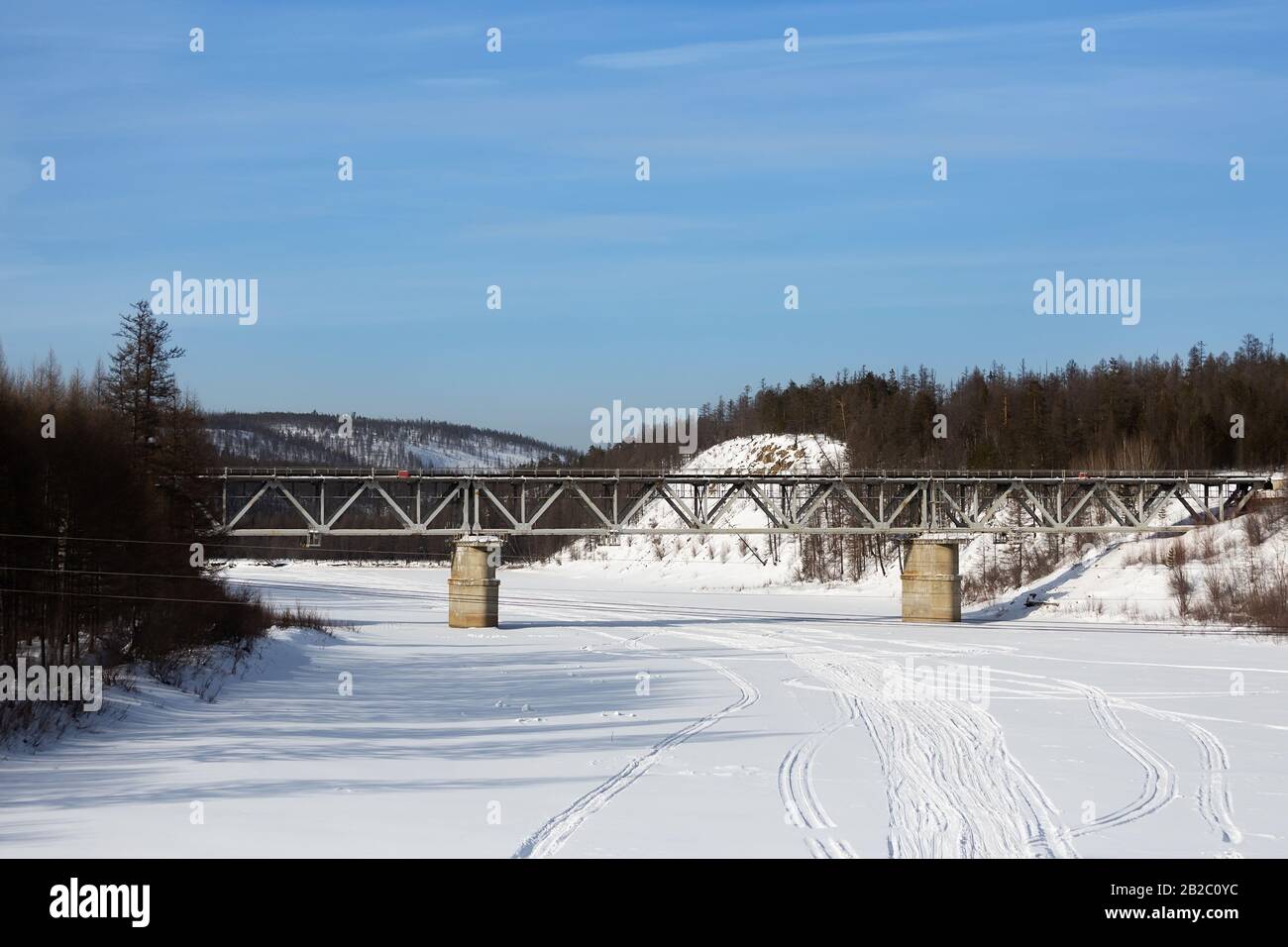 Pont ferroviaire au-dessus de la rivière Chulman dans le sud de Yakutia, en Russie, en hiver. Banque D'Images