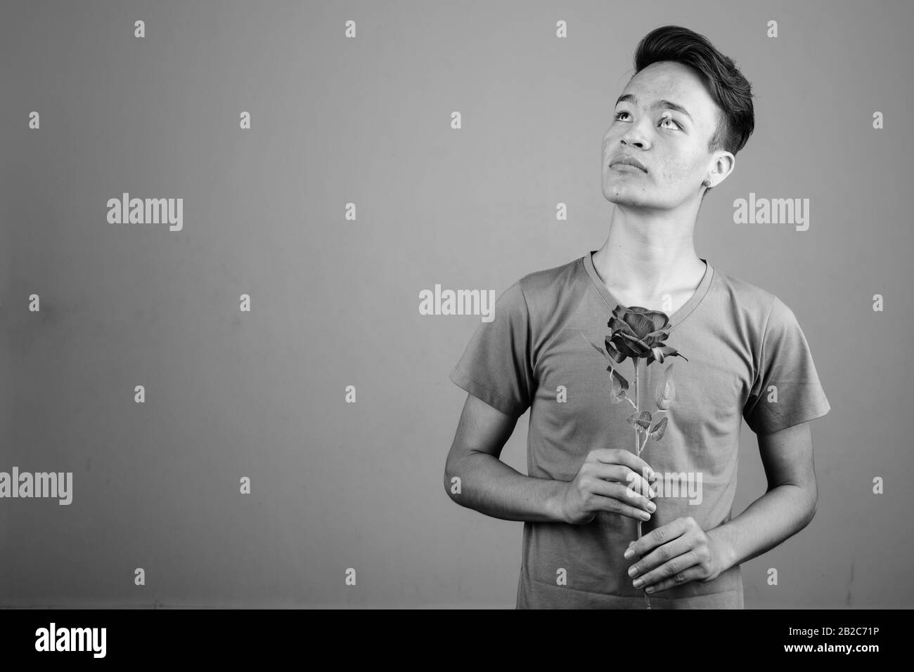 Beau jeune homme indien contre l'arrière-plan gris Banque D'Images