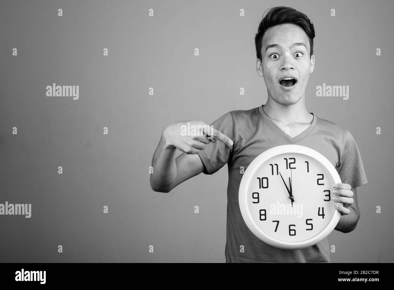 Beau jeune homme indien contre l'arrière-plan gris Banque D'Images