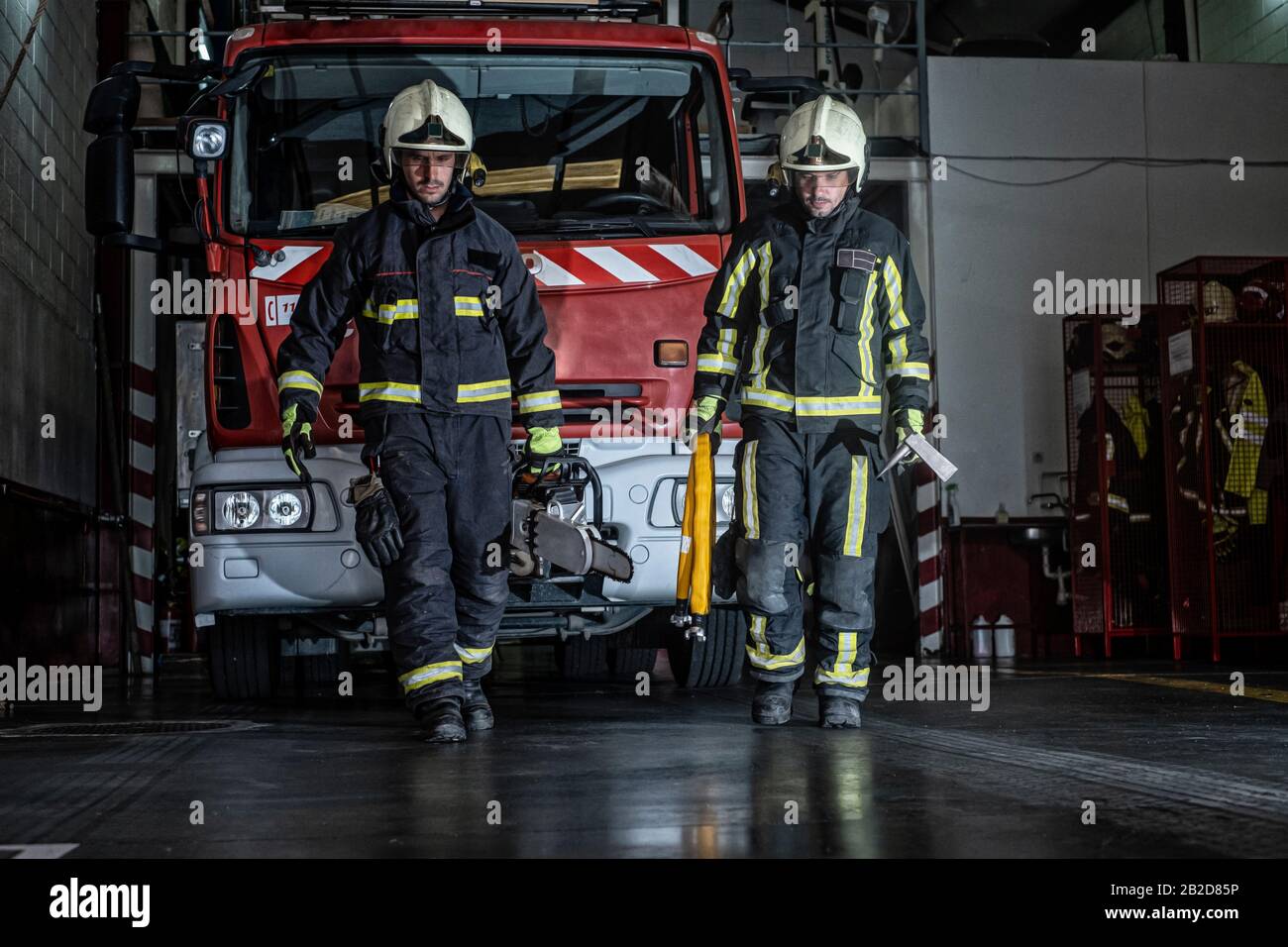 pompiers quittant la station équipée et avec les outils pour l'extinction du feu Banque D'Images