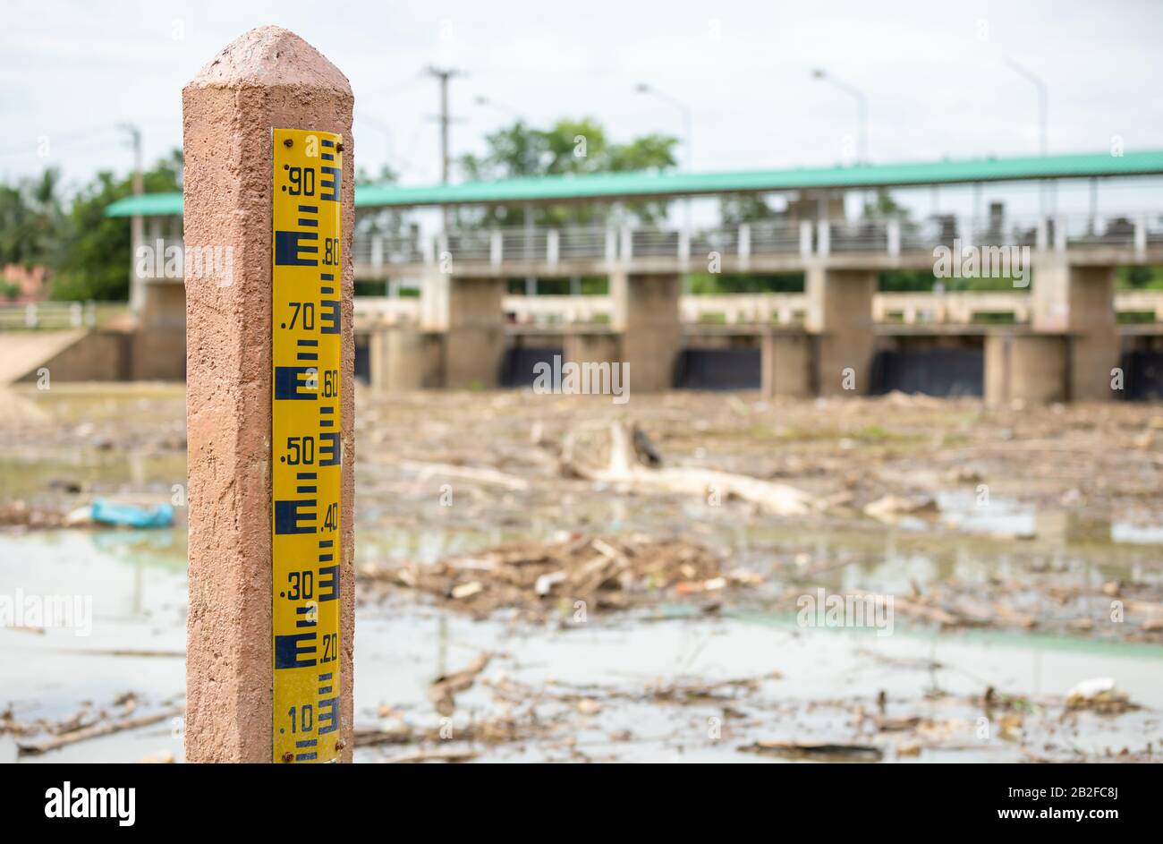 Nombre jaune de jauge de niveau d'eau sur le poteau au barrage. Flou arrière de barrage en Thaïlande Banque D'Images