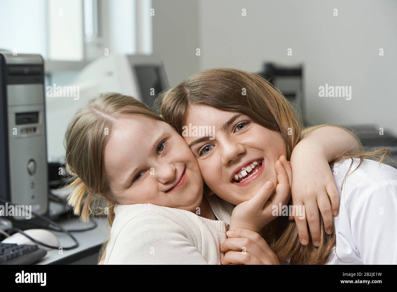 Portrait de deux sœurs (10-15) embrassant Banque D'Images