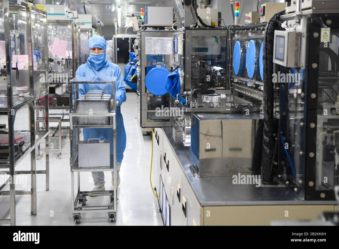 Chongqing, Chine. 3 mars 2020. Un travailleur se promène à l'atelier d'emballage de l'oscillateur à quartz de la TXC (Chongqing) Corporation dans la zone de haute technologie de Chongqing, dans le sud-ouest de la Chine, le 3 mars 2020. La zone de haute technologie de Chongqing a mis en place des politiques visant à aider les entreprises à reprendre leur production lors de la lutte contre le nouveau coronavirus. Au total, 1 598 entreprises de 102 894 travailleurs de la zone ont repris leur production et leur fonctionnement d'ici à midi du mardi. Crédit: Wang Quinchao/Xinhua/Alay Live News Banque D'Images