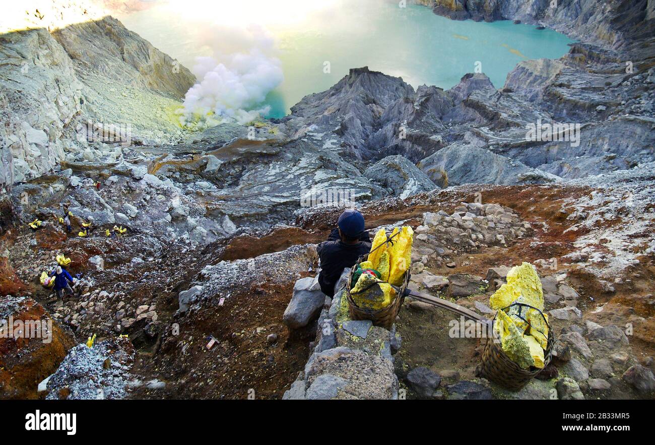 MINER RECUEILLANT DU SOUFRE SUR LE VOLCAN KAWAH IJEN À JAVA ISLAND-INDONÉSIE Banque D'Images