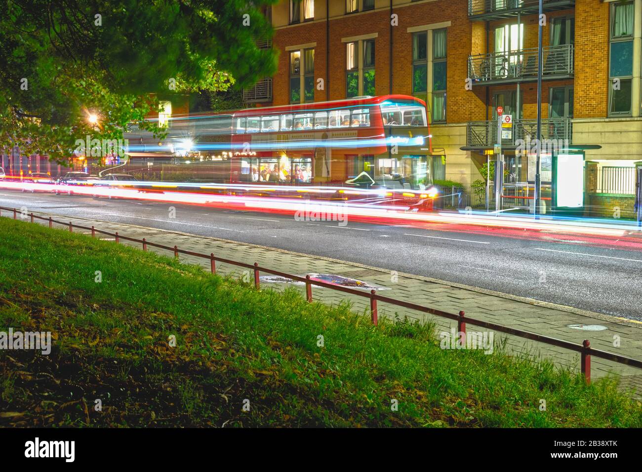 Une longue exposition d'un bus rouge numéro 18 sur la route de herse à kensal Green, nord-ouest de Londres. Banque D'Images