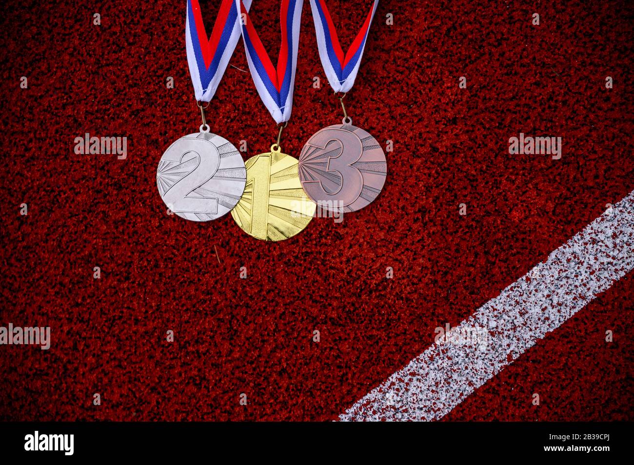 Médailles d'arbre sur piste d'athlétisme, fond de sport, espace de montage rouge, fond d'écran de la victoire. Photo originale pour le jeu d'été 2020 à Tokyo Banque D'Images