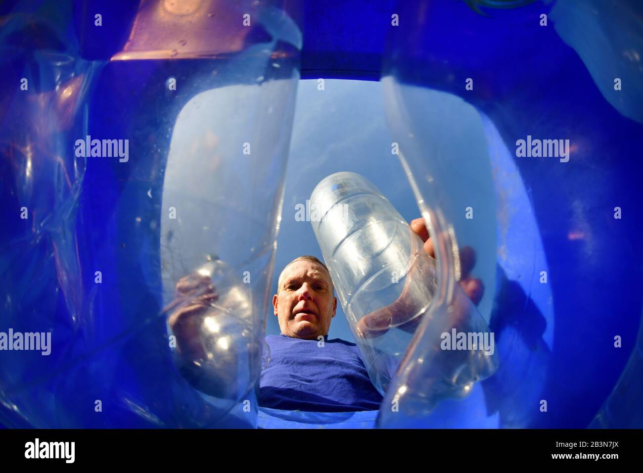 homme mettant des bouteilles en plastique dans la circonscription est du yorkshire recyclage wheie bin ellerton yorkshire royaume-uni Banque D'Images