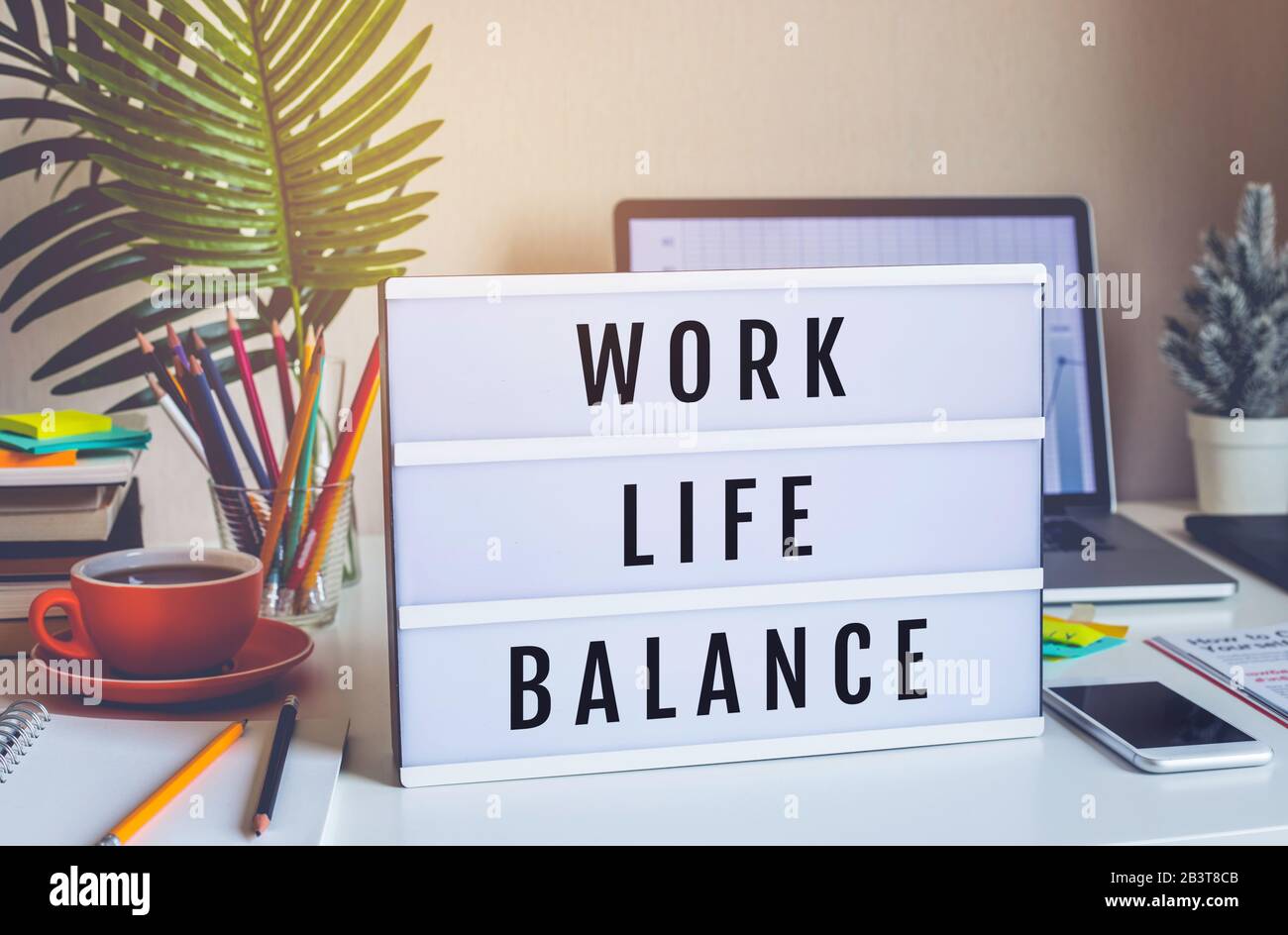 Concepts d'équilibre de la vie professionnelle avec texte sur la case de lumière sur la table de bureau dans le bureau à domicile.émotion positive au succès.corps sain Banque D'Images