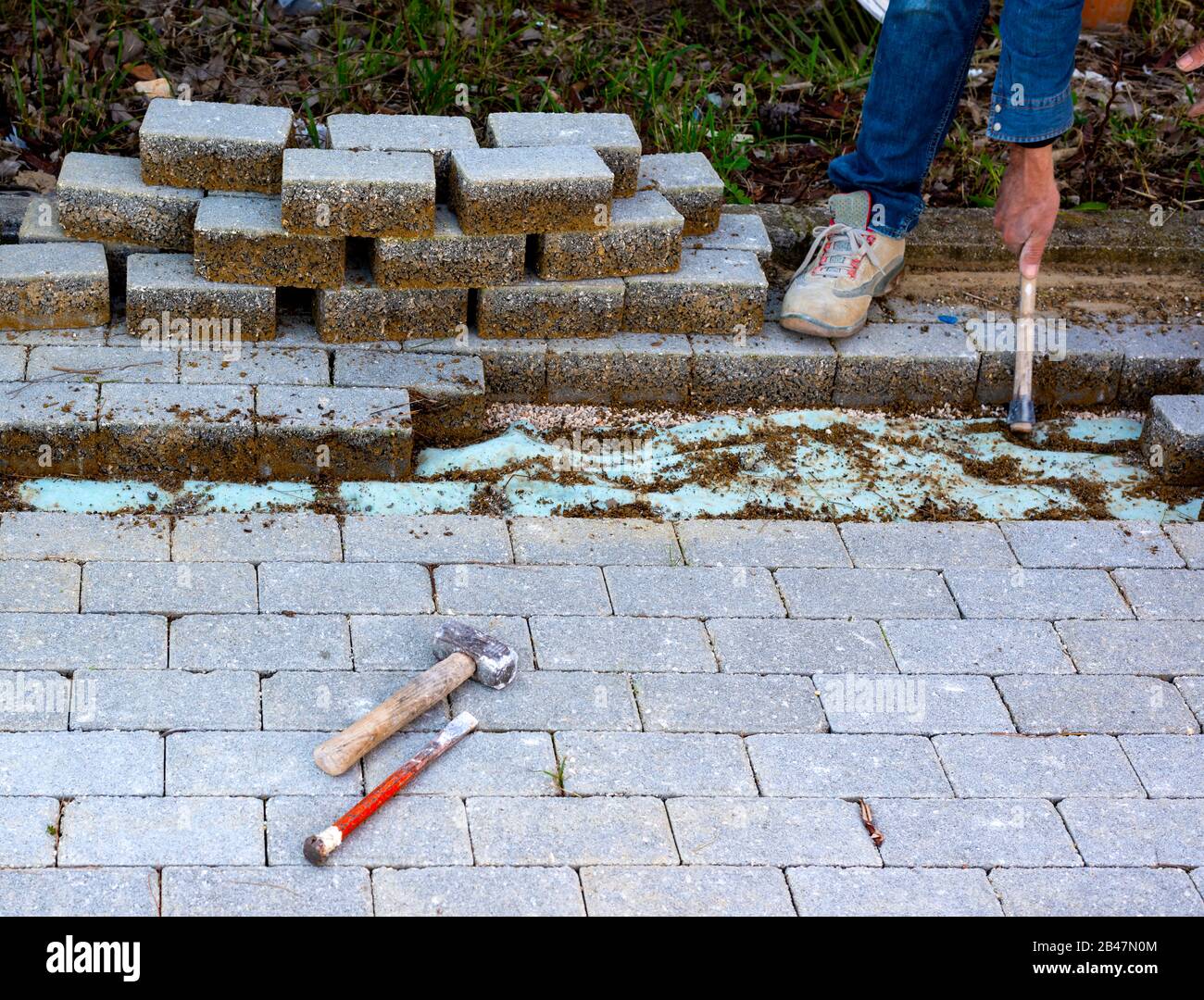 Travaux de maintenance sur l'asphaltage des pavés imbriqués. De l'industrie des matériaux de construction, produits en béton pour la route ou la construction d'un trottoir. Banque D'Images
