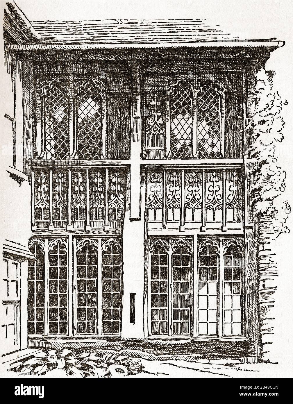 Hôtels, pubs, auberges et tavernes britanniques. Vers les années 1930 photographie d'une partie des bras Luttrell à Dunster (Royaume-Uni) - fenêtres gothiques dans le Hall des abbés Banque D'Images