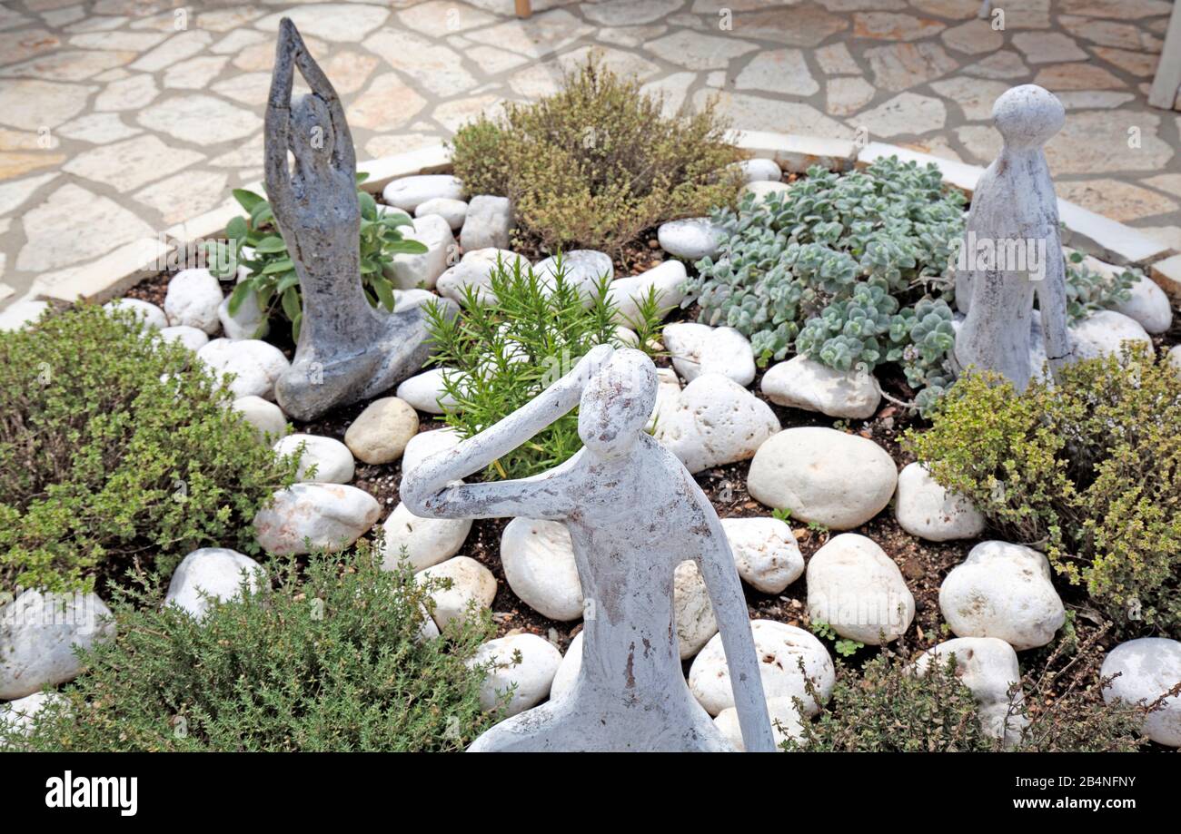 Figures avec le thème de la méditation dans un jardin d'herbes. Péloponnèse Grèce Banque D'Images