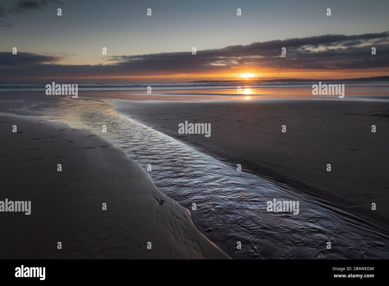Coucher de soleil sur la plage d'Aberavon Banque D'Images
