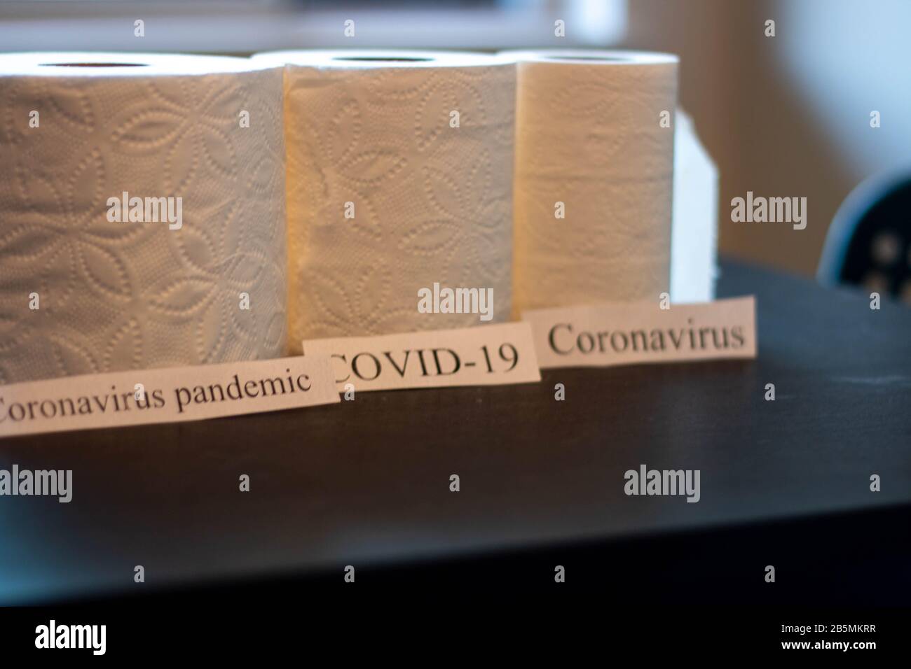 Coronavirus à côté de rouleaux de papier toilette. Thème de l'approvisionnement sur les fournitures Banque D'Images