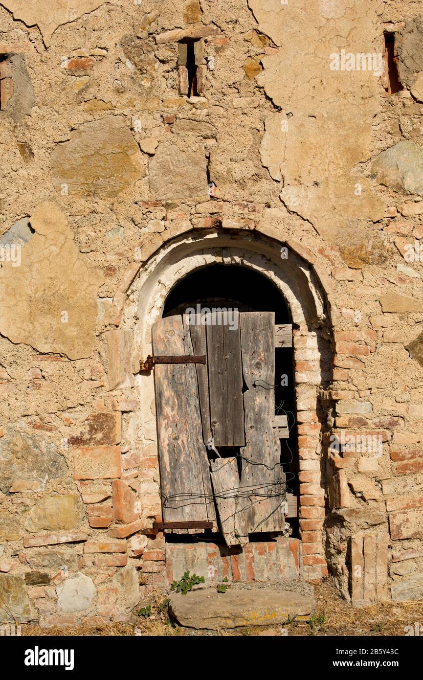 Une vieille porte en bois dans un bâtiment en Toscane Italie Europe. Banque D'Images