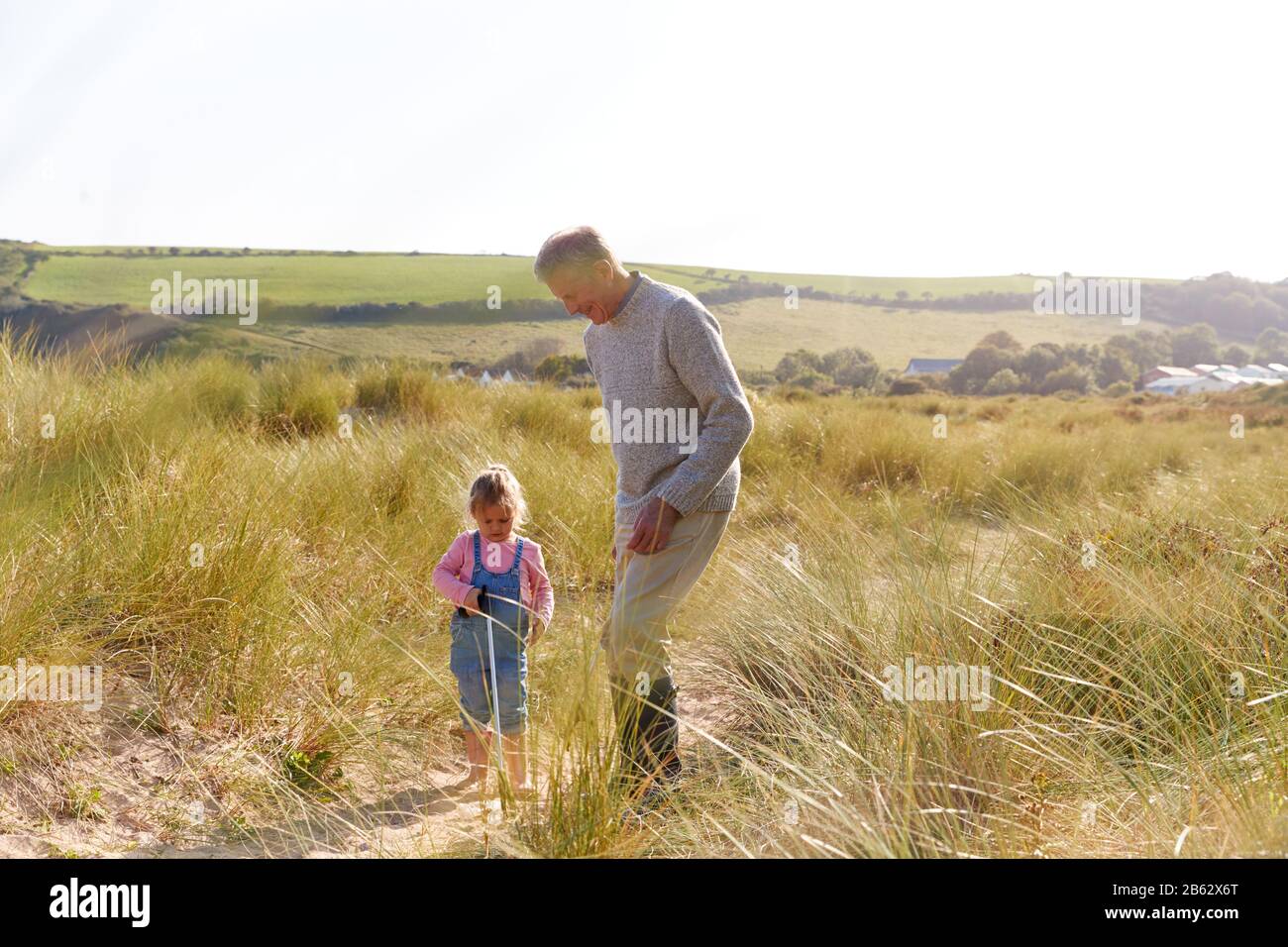 Grand-Père Et Petite-Fille Qui Collectent De La Litière Sur Winter Beach Clean Up Banque D'Images