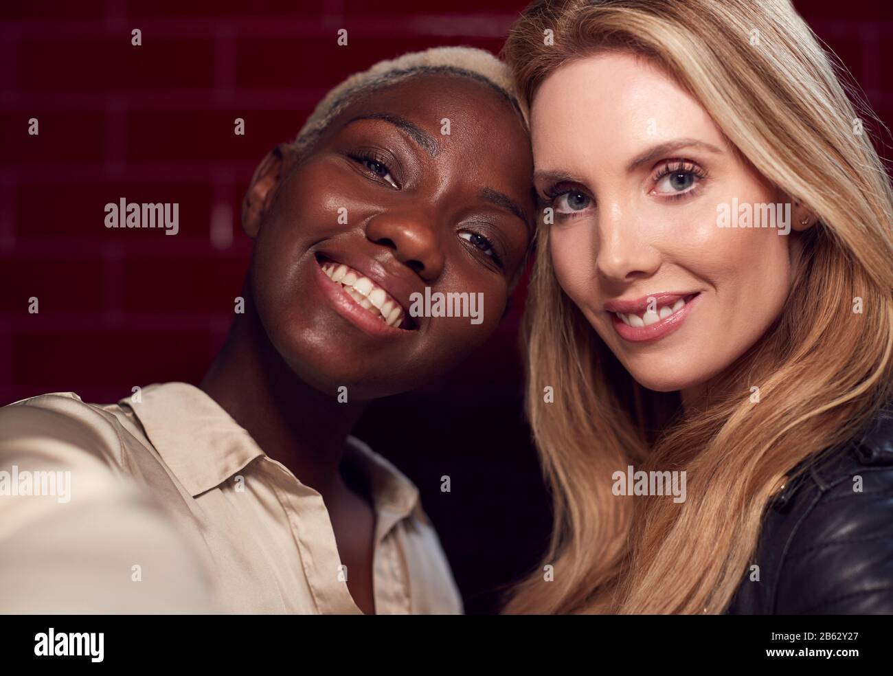 Deux Jeunes Amis Femmes Posant Pour Selfie Se Reflète Dans Miroir De Salle De Bains Dans Le Club Banque D'Images