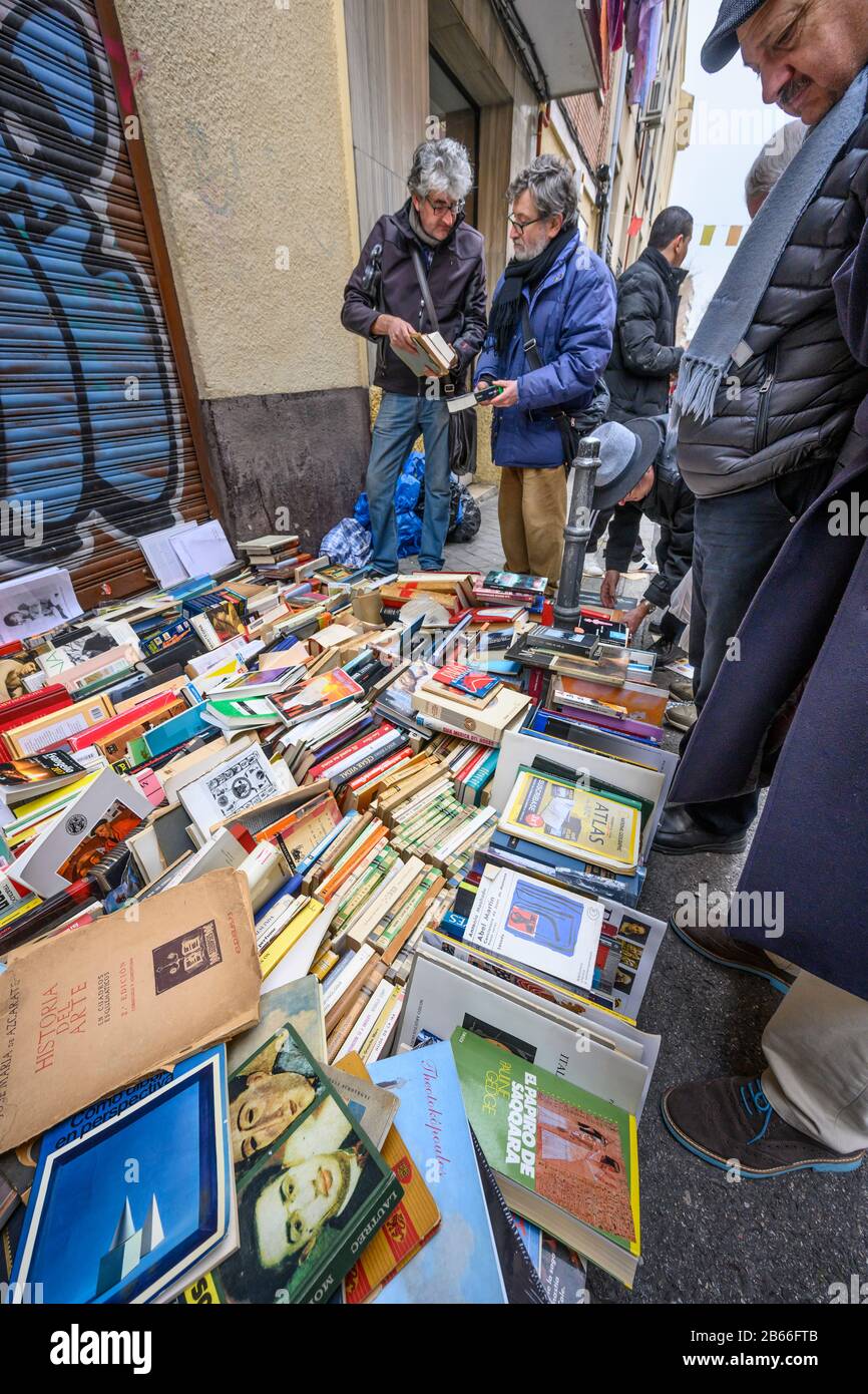 Les chasseurs de bonnes affaires parcourent des livres dans le marché aux puces de Rastro autour de la Plaza de Cascorro entre la Latina et Embajadores, Madrid, Espagne. Banque D'Images